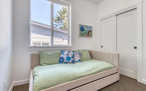 a room with a couch and a window at Harbor Lights #1 - New Construction Townhome in Depoe Bay