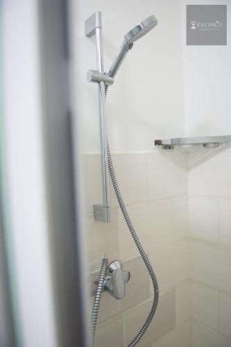 a shower with a shower head in a bathroom at HHC Apartments Kronos in Paramaribo