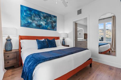 a bedroom with a large bed and a mirror at Superb NEW 2BR amazing amenities in Salt Lake City