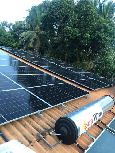 a group of solar panels on top of a roof at Murphy's Transit Villa Airport Pick & Drop Katunayake in Katunayake