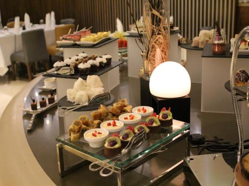 a buffet line with different types of pastries on display at Ramada by Wyndham Dubai Barsha Heights in Dubai