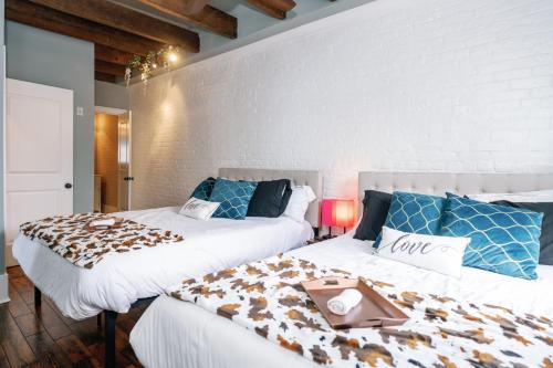 a bedroom with two beds with a tray on them at Decatur Sugar Mill Blues in New Orleans