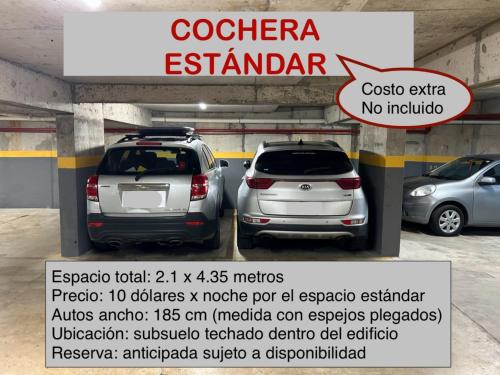 two cars are parked in a parking lot at EUGE Apart in Montevideo