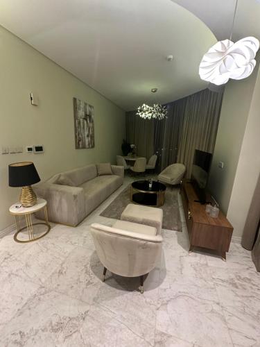 a living room with a couch and a table at Flat one bedroom next to four sessions شقه مقابل فندق فور سيزن in Manama