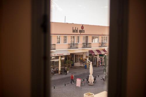 a view of a street from a window of a building at Hotel Opera in Larnaca