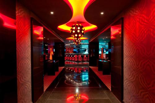 a room with a bar with red and yellow lights at JW Marriott Hotel Ankara in Ankara