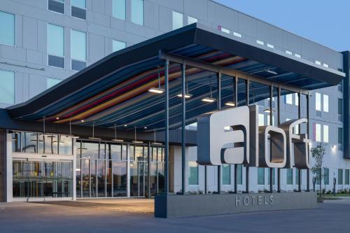 a building with a large sign in front of it at Aloft Oklahoma City Quail Springs in Oklahoma City