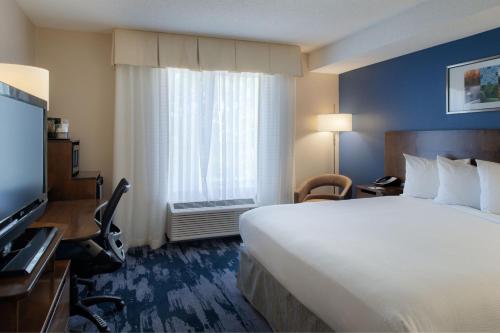 a hotel room with a large bed and a window at Fairfield by Marriott in Troy