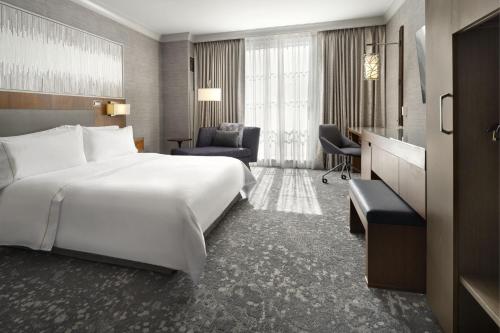 a hotel room with a large bed and a desk at The Westin Palo Alto in Palo Alto