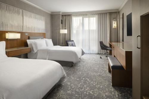a hotel room with two beds and a desk at The Westin Palo Alto in Palo Alto