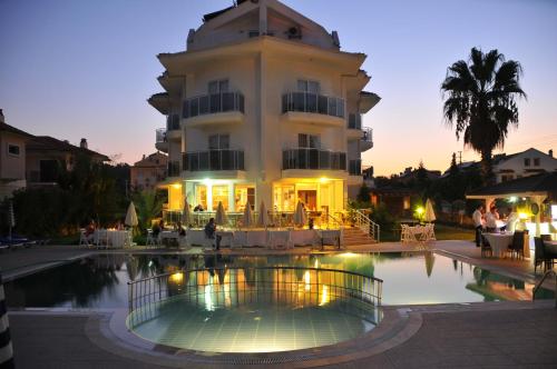 a building with a pool in front of a building at Nevada Hotel & Spa in Fethiye