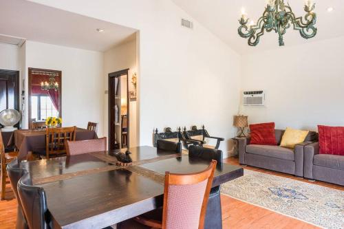 a living room with a table and a couch at Entire Second Flr - Santa Monica Luxury Roman Villa in Los Angeles