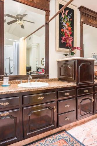 a bathroom with a sink and a large mirror at Entire Second Flr - Santa Monica Luxury Roman Villa in Los Angeles