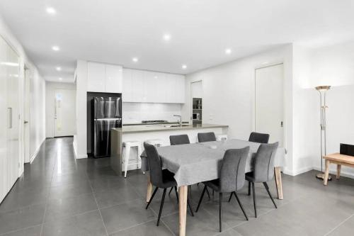 a kitchen and dining room with a table and chairs at Seaside Retreat, St Leonards in Saint Leonards