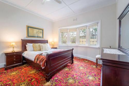 a bedroom with a bed and a window at Cambridge House, Bendigo in Bendigo