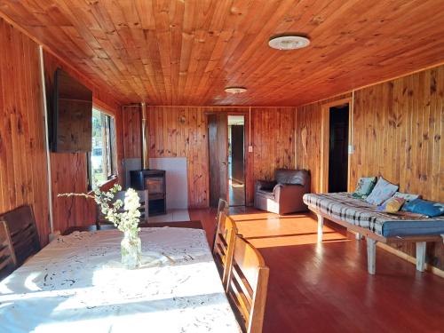 a living room with a couch and a table at Hermosa Casona en los Muermos in Los Muermos