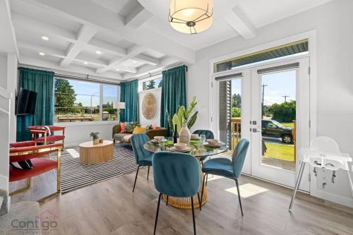 a living room with a table and chairs at Urban Jungle Getaway, AirCon, 10min to DT & WEM! in Edmonton
