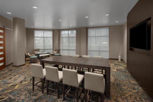 a conference room with a table and chairs and a television at Residence Inn by Marriott Durham Duke University Medical Center Area in Durham