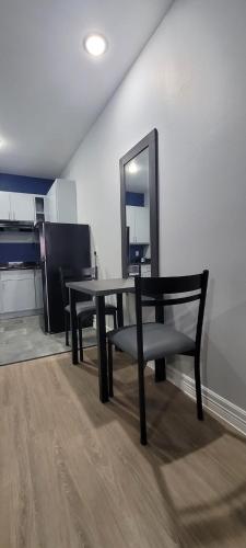 a dining room table with a chair and a mirror at Platinum Inn 99 and Morton Ranch in Katy