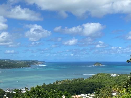 a view of the ocean with islands in the distance at Top Hill Appartements in La Trinité
