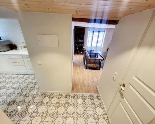 a kitchen with a door leading to a living room at OAH 1870 Oldest Alesund House in Ålesund
