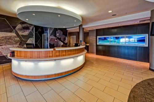 a lobby with a circular counter and a tv at SpringHill Suites by Marriott Oklahoma City Moore in Moore