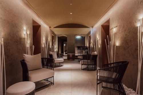 a hallway with chairs and tables in a room at Casa Cipriani Milano in Milan