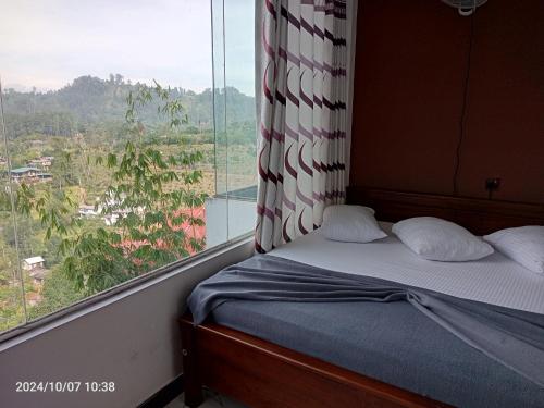a bed in a room with a large window at 240 - Two forty in Bandarawela