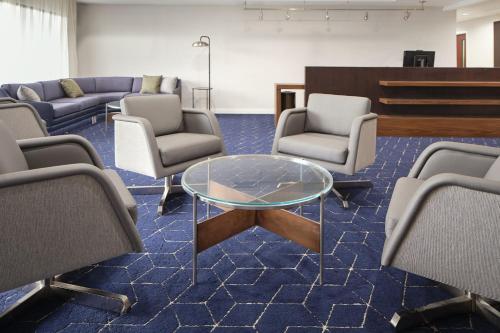 a waiting room with chairs and a glass table at Courtyard Florence South Carolina in Florence