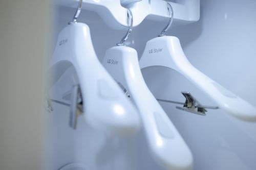 a group of white urinals hanging from a wall at Aank Air Hotel Jinjuseong in Jinju