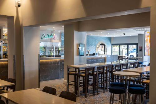 a restaurant with tables and chairs and a bar at Royal Hotel Randwick in Sydney