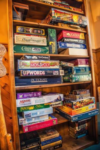 a stack of books on a book shelf at Eagle's Nest in Big Bear Lake