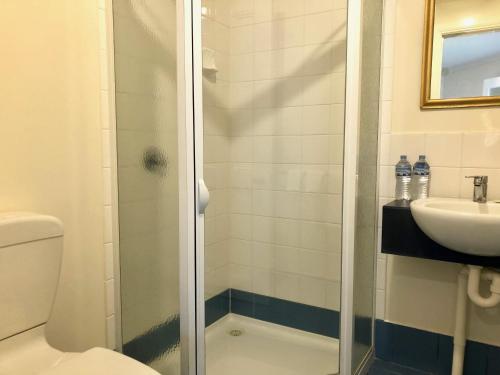 a bathroom with a shower and a toilet and a sink at Douglas Riverside in Port Fairy