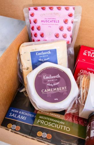 a box filled with different types of cheese at Netanya Noosa Beachfront Resort in Noosa Heads