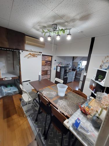 a kitchen and dining room with a table and chairs at つきびとはうす in Satte