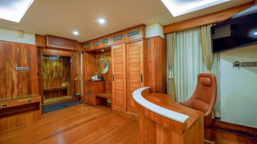 a living room with wooden paneling and a television at Chandys Drizzle Drops - Munnar Top Station in Munnar