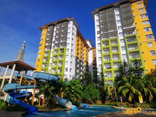 zwei hohe Gebäude mit einer Wasserrutsche davor in der Unterkunft Melaka B- Lagoon Resort FREE 4 & 6 Waterpark ticket in Malakka