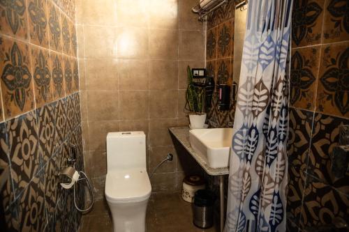 a bathroom with a toilet and a sink at Maatidera Resort Kanatal The Boutique stay in the Lap of Himalayas in Kanatal