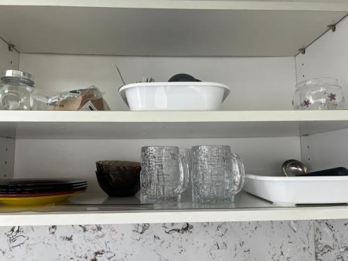 a shelf with glasses and bowls on it at Brilliant location 3 in Ulaanbaatar