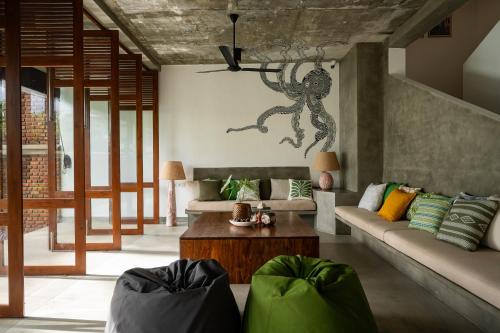 a living room with a couch and a table at Soorya Kala in Hikkaduwa