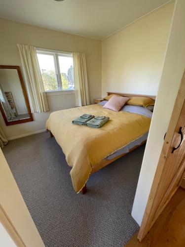 a bedroom with a large bed and a window at Eden Cottage, Wedderburn in Wedderburn