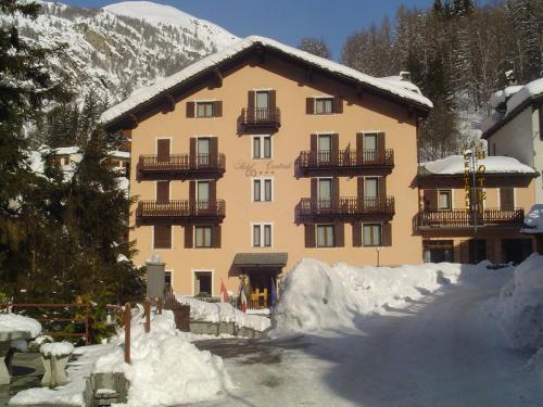 a large building with snow in front of it at Centrale in Courmayeur