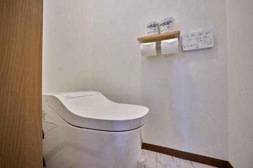 a bathroom with a toilet and two rolls of toilet paper at Fuji Holiday in Fujiyoshida