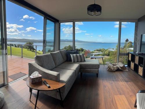 a living room with a couch and a view of the ocean at 4 Scenic Court in Mallacoota