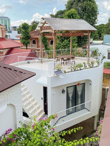 a white house with a gazebo on top of it at DƯỚI TÁN CÂY homestay in Tây Ninh