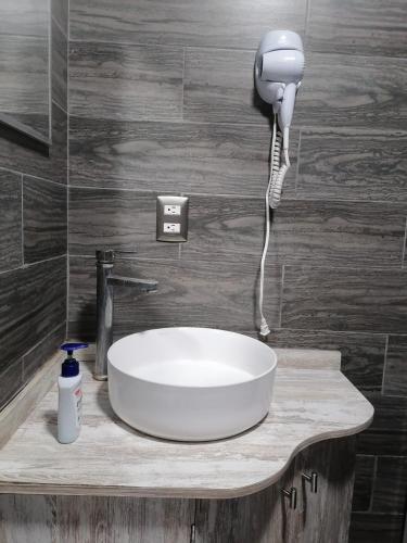 a sink with a phone on a counter in a bathroom at Casa los Arcos Oaxaca in Oaxaca City