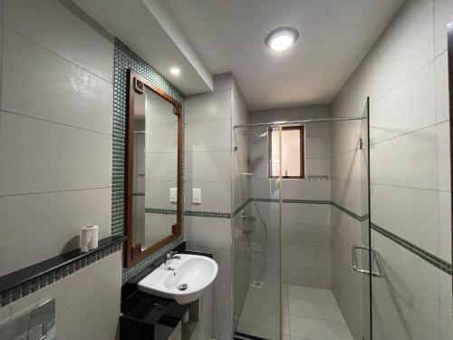 a bathroom with a glass shower and a sink at Bahari Haven TWO Bedroom Kikambala in Kilifi