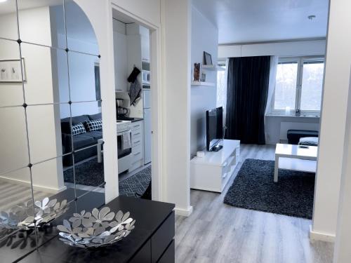 a large white living room with a large mirror at Cozy 1BR City Centre Home with Free Parking in Kuopio