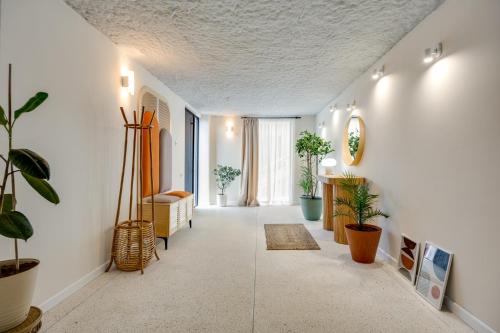 a living room with white walls and plants at Old Town Panorama View in Tbilisi City