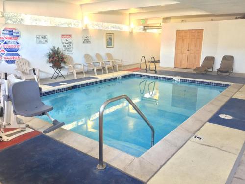 a swimming pool with a chair and a chair lift at Pleasant Hill Inn in Pleasant Hill